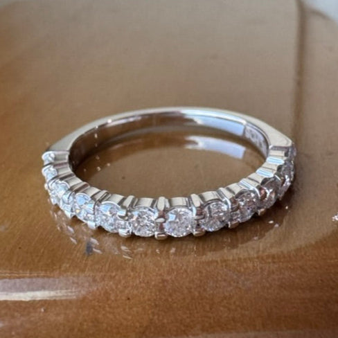 White gold ring with diamonds on a wooden surface
