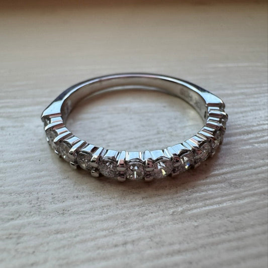 White gold ring with diamonds on a wooden surface
