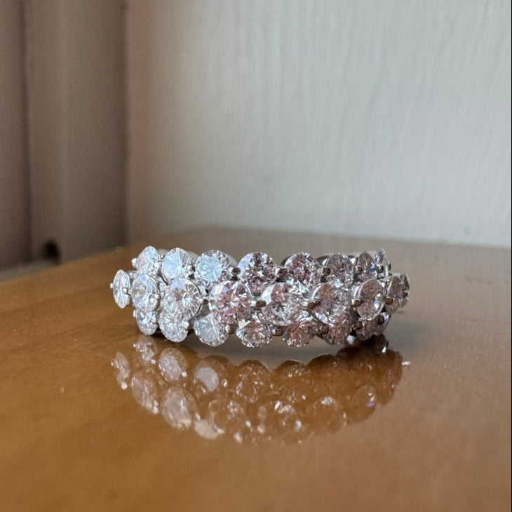 Diamond ring on a reflective surface with a neutral background
