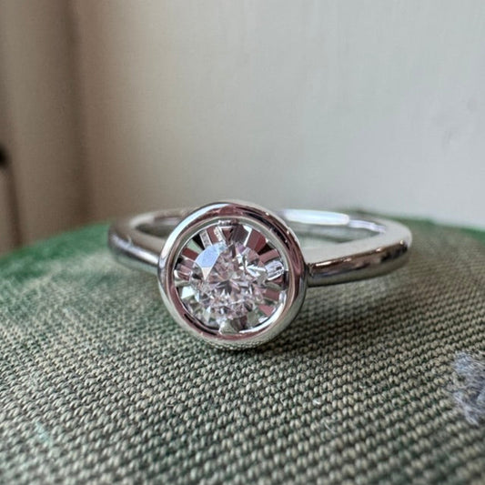 Diamond ring on a textured surface with a neutral background
