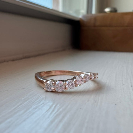 Yellow gold ring with diamonds on a light surface