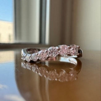 White gold ring with diamonds on a reflective surface