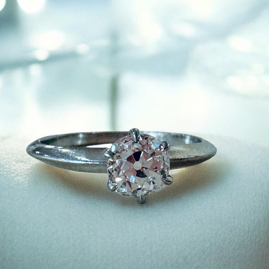 Silver ring with a diamond on a light background