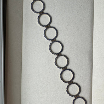 Bracelet with circular links in a white box