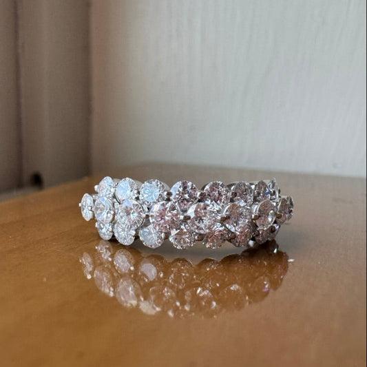 Diamond ring on a reflective surface with a neutral background